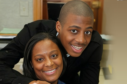 Two smiling people posing together indoors at Ferguson Dental office